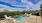 a pool with a deck and trees